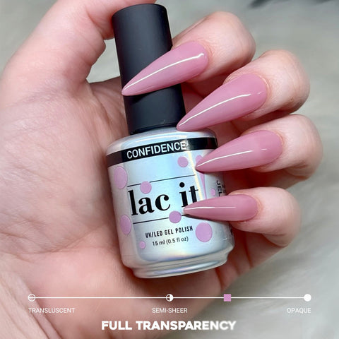 en Vogue Lac it! confidence rosy mauve jelly UV/LED gel polish for professional nails and extensions shown on long stiletto nails holding polish bottle