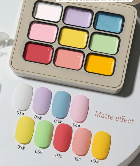Nine-pan gel palette with white, lilac, baby blue, pink, yellow, green, coral-red, peach and golden-yellow colours, shown with matte-effect swatches