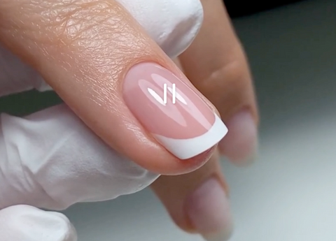 Close-up of a perfect French manicure created with Akzentz Perfect French Gel — crisp white smile line on a natural nail