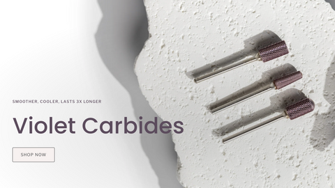 Violet carbide burrs on a textured white surface with 'Violet Carbides' text.