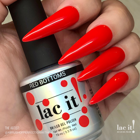 en Vogue Lac It! Red bottoms bright poppy red crème UV/LED gel nail polish for professional nails and extensions on long stiletto nails holding polish bottle