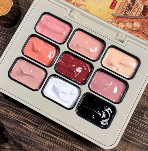 Open nine-colour gel palette with pink, peachy nude, coral, deep red, dusty rose, white and black shades